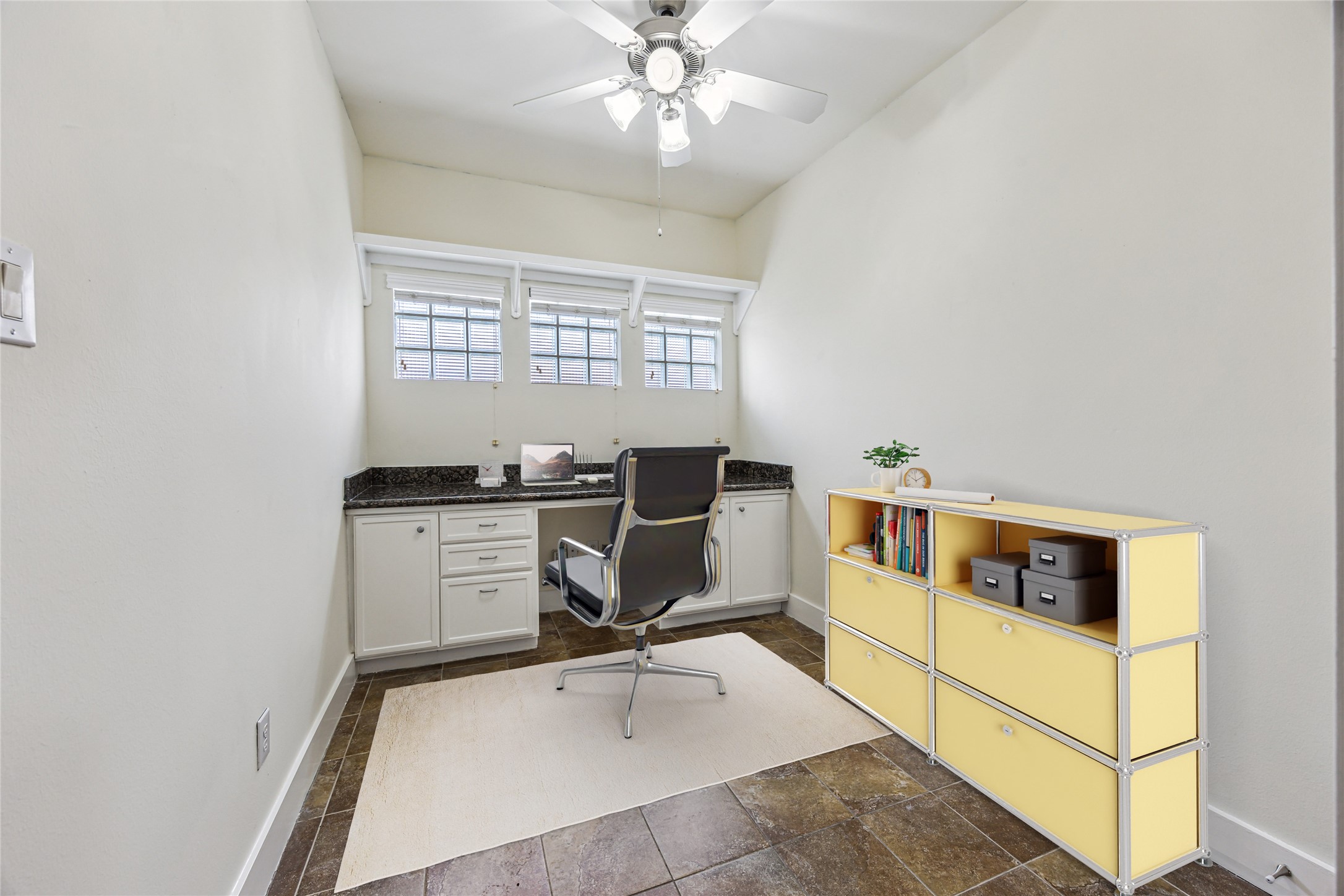 9829 Riddlelink Lane Houston, TX 77025 - Photo 17 of 22 **Virtually Staged** Versatile downstairs study or hobby room with built-in desk, granite counter, and cabinetry for added workspace and storage.