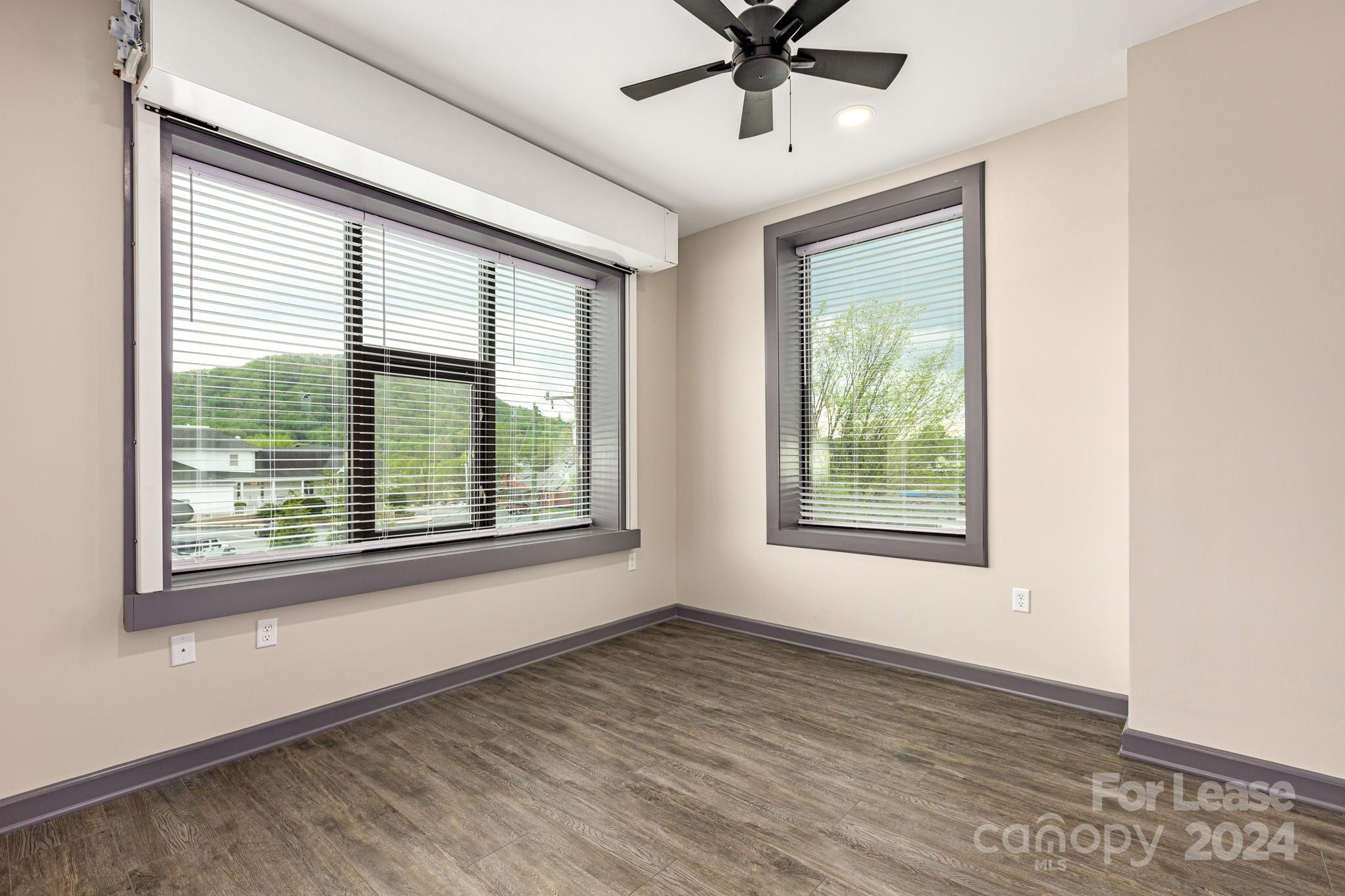 138 South Main Street, Unit D Marion, NC 28752 - Photo 4 of 11 a view of an empty room with a window and wooden floor
