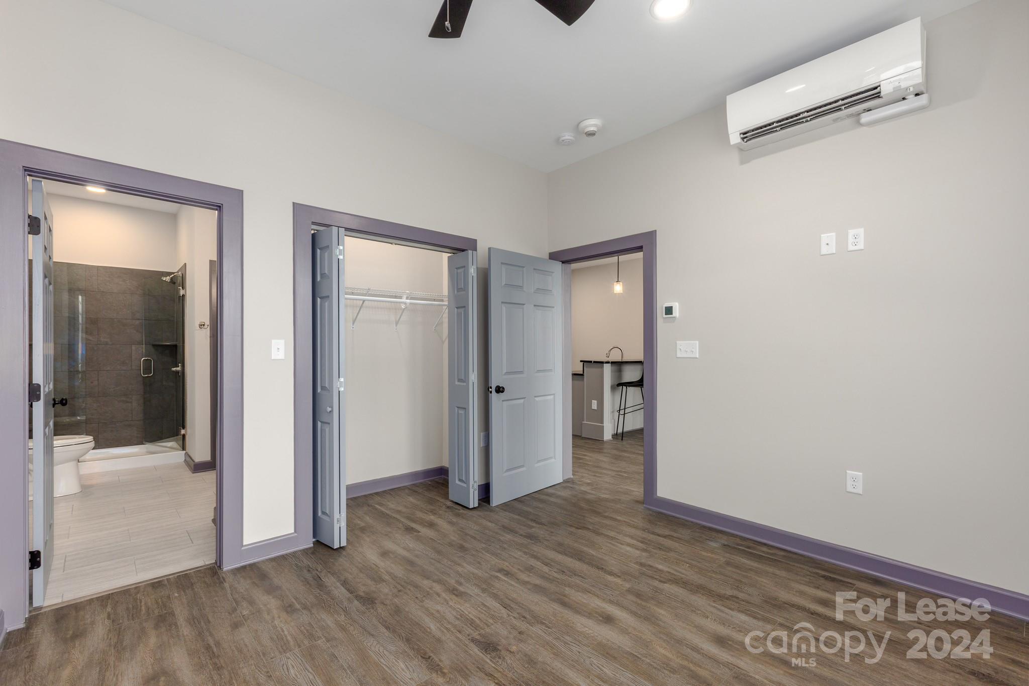 138 South Main Street, Unit D Marion, NC 28752 - Photo 5 of 11 an empty room with wooden floor and windows