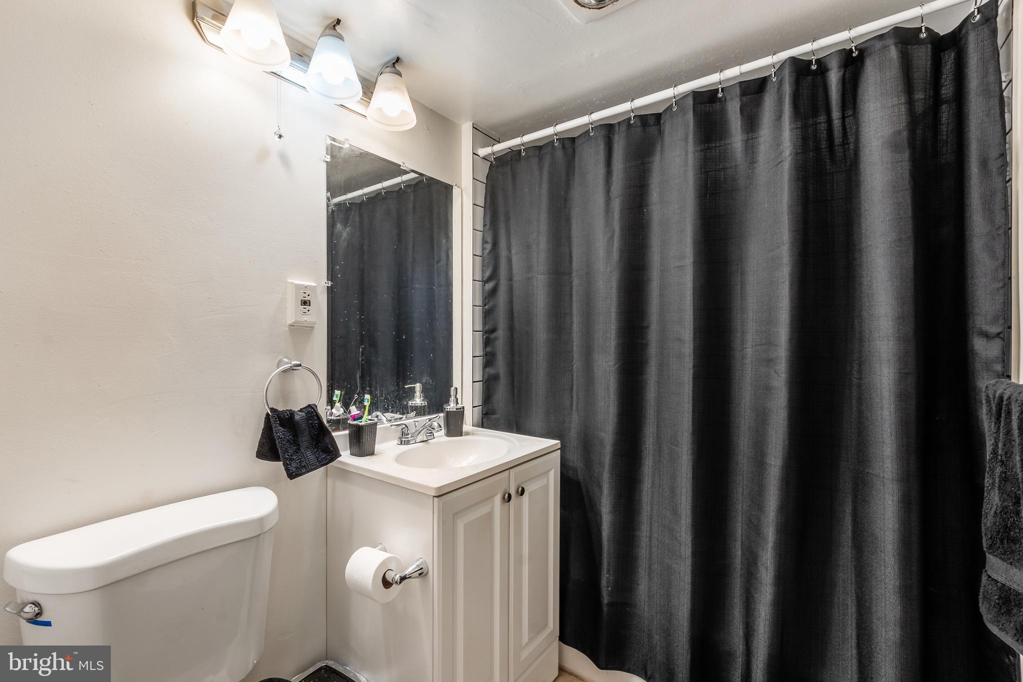 3814 V Street Southeast, Unit 101 Washington, DC 20020 - Photo 17 of 19 a bathroom with a sink a toilet and shower