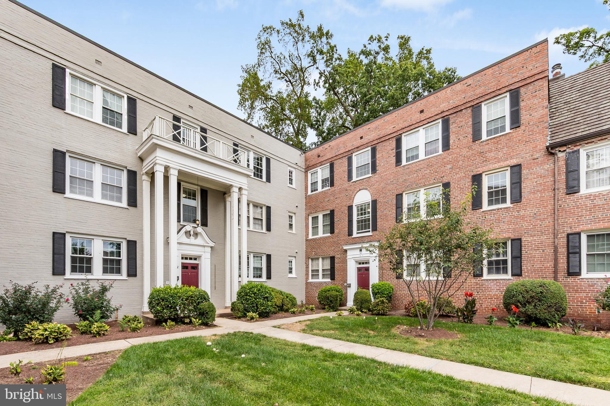 3814 V Street Southeast, Unit 101 Washington, DC 20020 - Photo 2 of 19 front view of a brick house with a yard