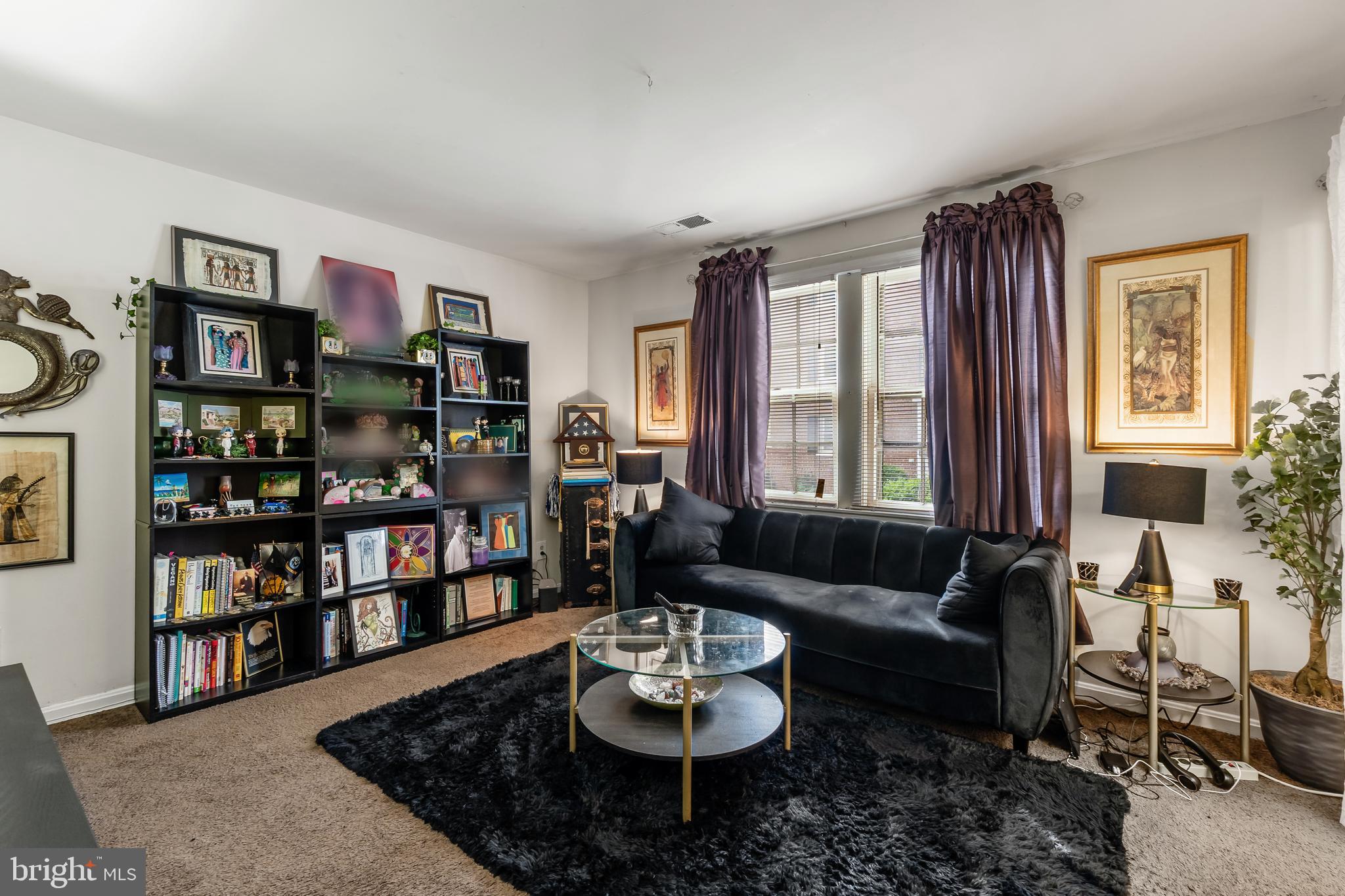 3814 V Street Southeast, Unit 101 Washington, DC 20020 - Photo 5 of 19 a living room with furniture and a book shelf