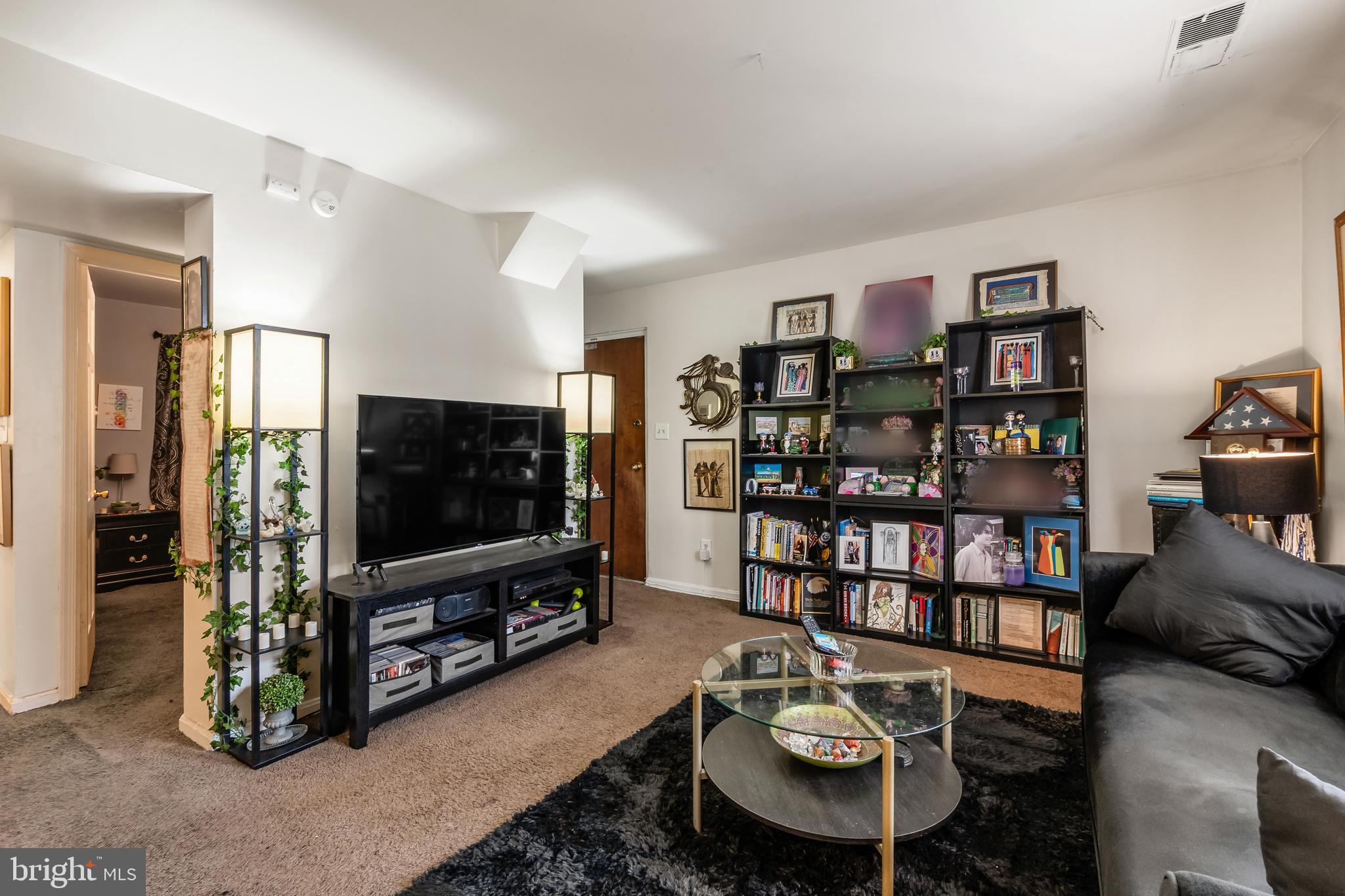 3814 V Street Southeast, Unit 101 Washington, DC 20020 - Photo 7 of 19 a living room with furniture and a flat screen tv