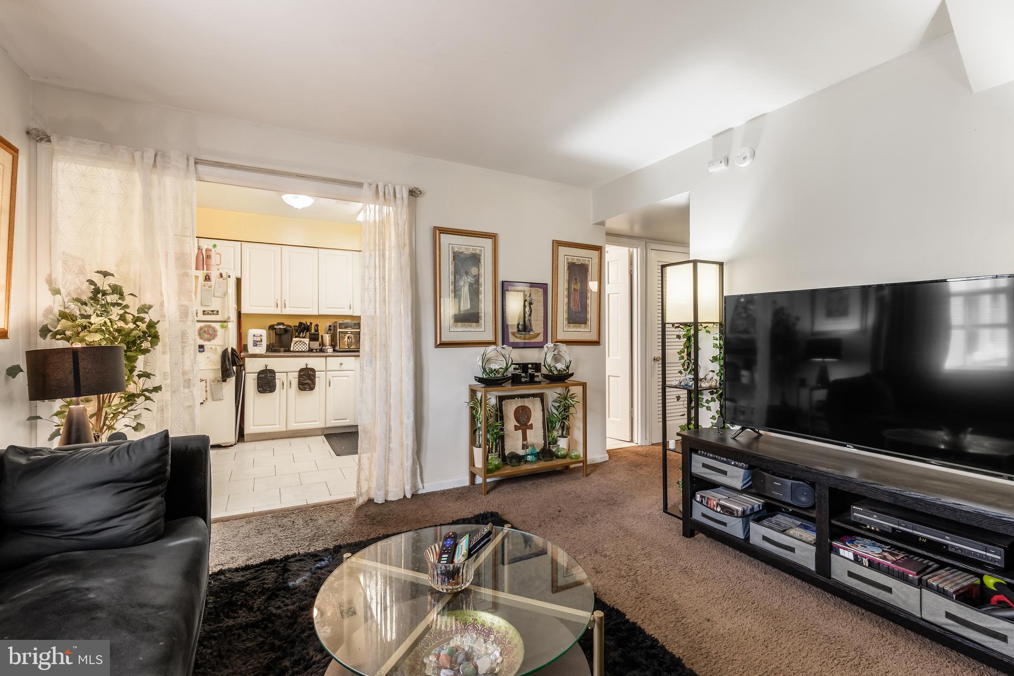 3814 V Street Southeast, Unit 101 Washington, DC 20020 - Photo 8 of 19 a living room with furniture and a flat screen tv