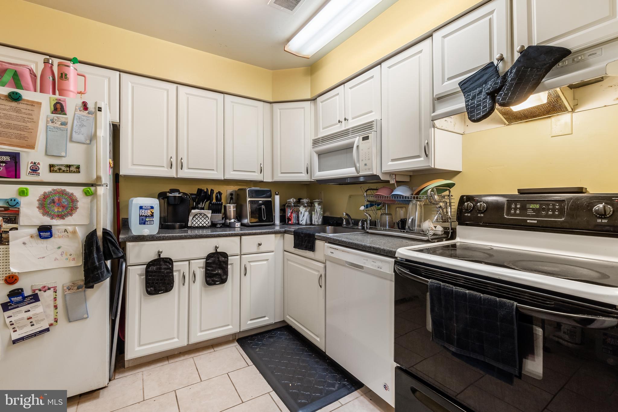 3814 V Street Southeast, Unit 101 Washington, DC 20020 - Photo 10 of 19 a kitchen with stainless steel appliances granite countertop a stove a sink and a refrigerator