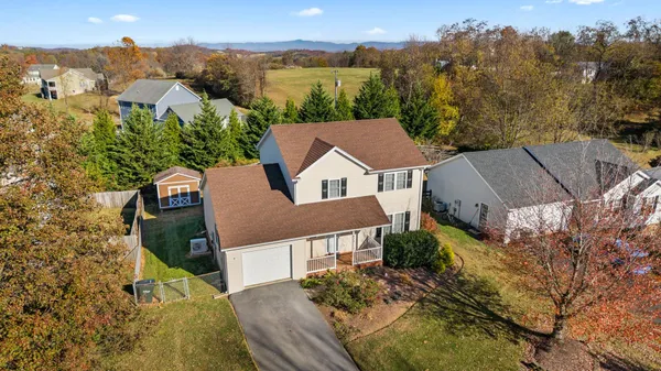 an aerial view of a house with a yard