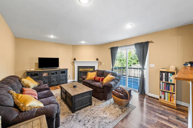 a living room with furniture a rug and a window