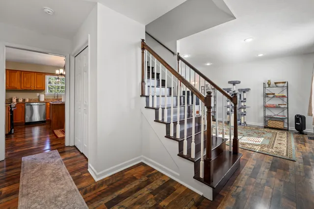 a large kitchen with sink a refrigerator and chairs
