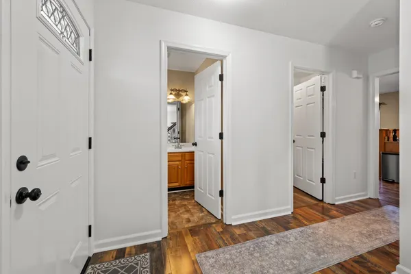 a large kitchen with sink a refrigerator and chairs