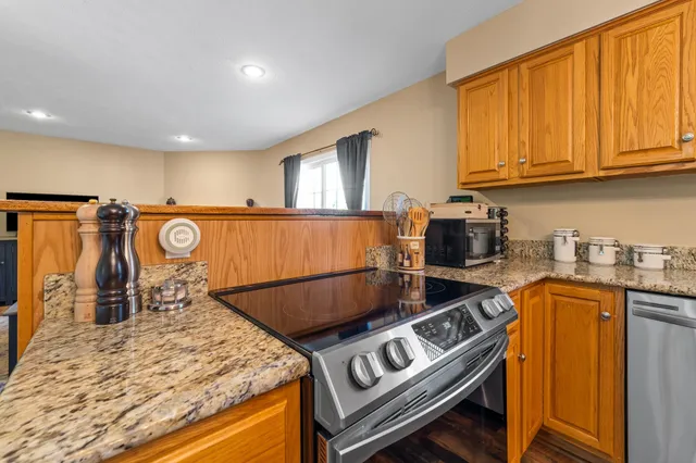 a kitchen with a table chairs and a refrigerator