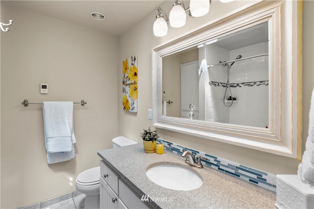 5 Winesap Road Bothell, WA 98012 - Photo 15 of 25 a bathroom with a granite countertop sink a toilet and a mirror