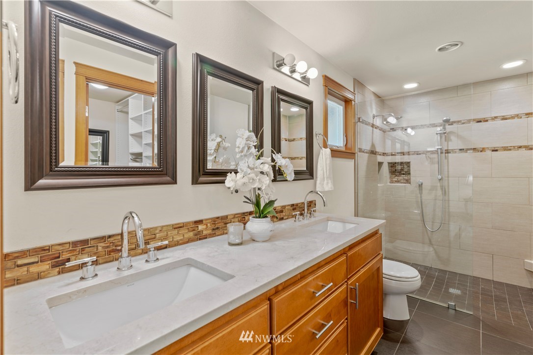 5 Winesap Road Bothell, WA 98012 - Photo 20 of 25 a bathroom with a granite countertop sink a toilet a mirror and shower