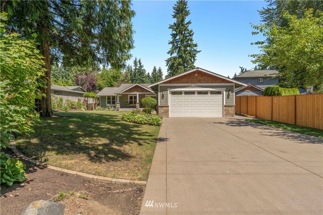 5 Winesap Road Bothell, WA 98012 - Photo 3 of 25 a front view of a house with a yard and garage