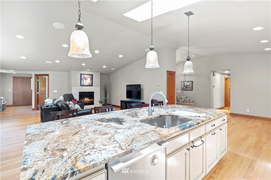 5 Winesap Road Bothell, WA 98012 - Photo 10 of 25 a view of a kitchen with kitchen island a dining table and chairs