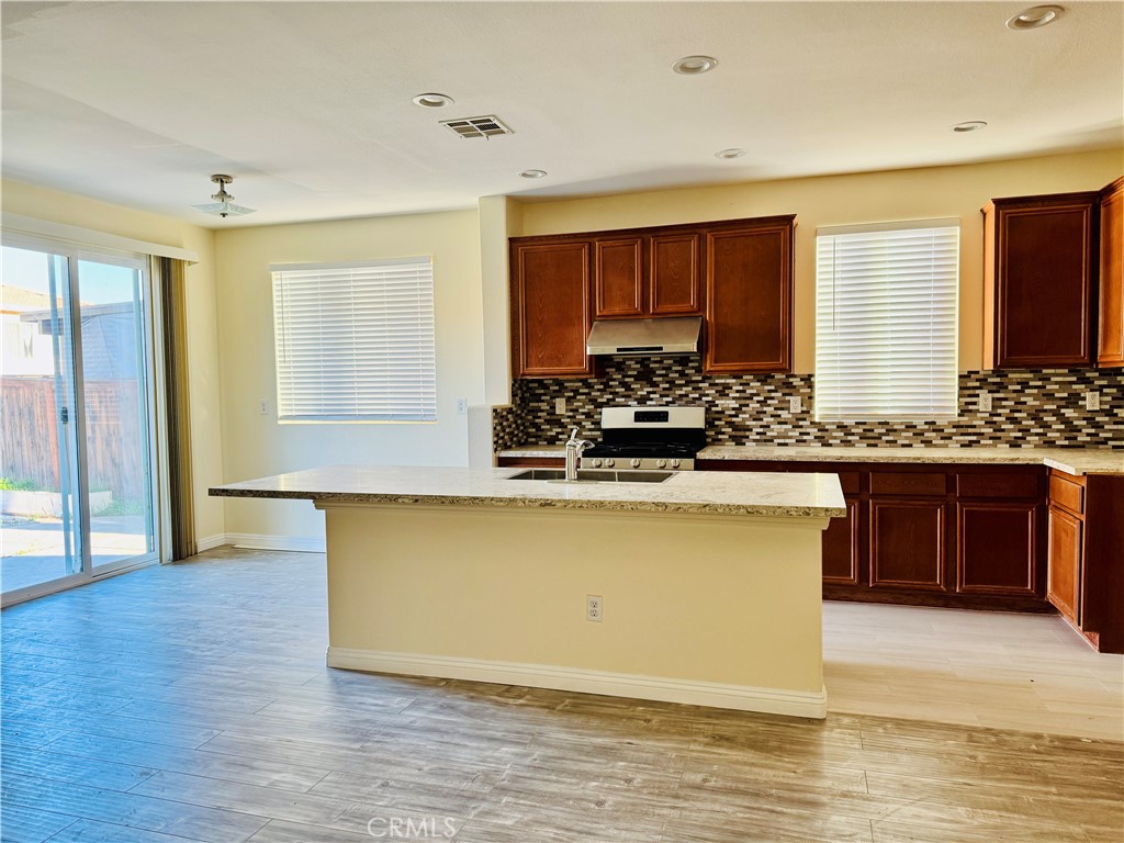 9329 Sable Ridge Avenue Hesperia, CA 92345 - Photo 15 of 31 a view of kitchen with stainless steel appliances granite countertop a stove a sink and a refrigerator