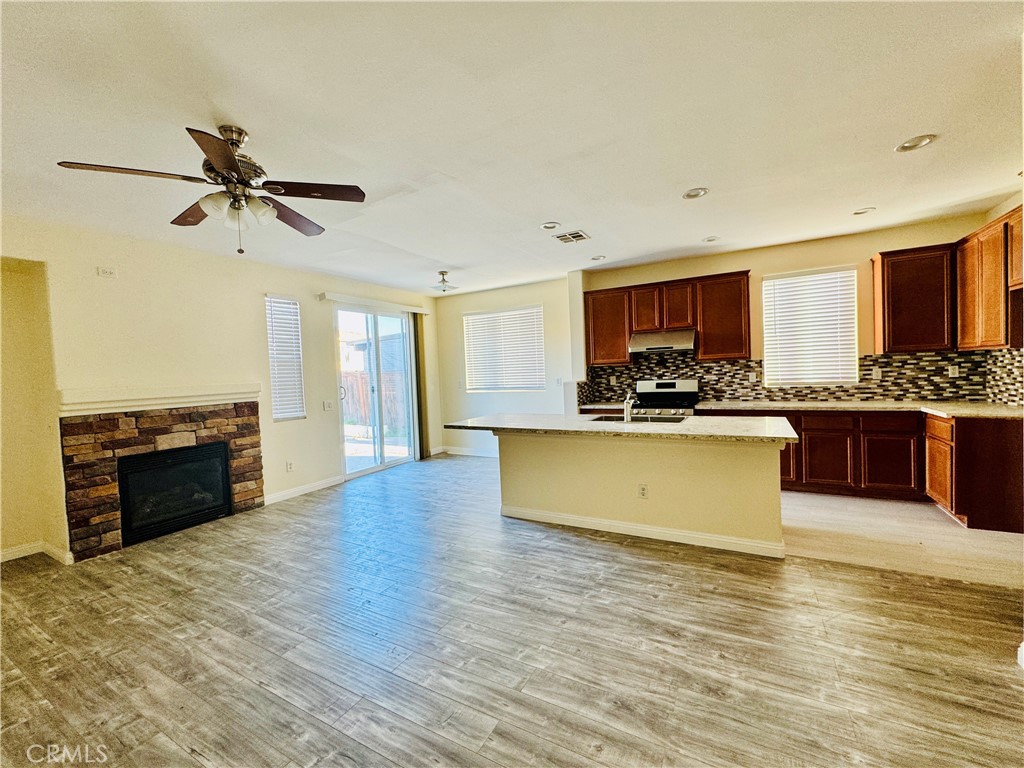 9329 Sable Ridge Avenue Hesperia, CA 92345 - Photo 16 of 31 a large kitchen with stainless steel appliances granite countertop a stove and a sink