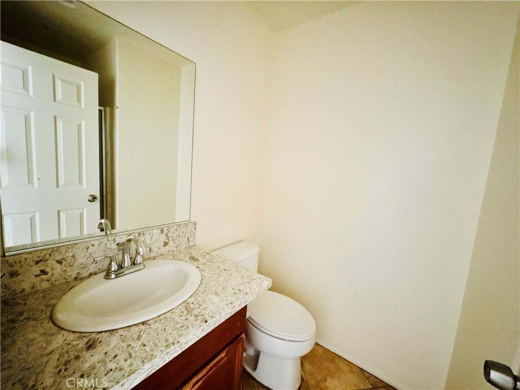 9329 Sable Ridge Avenue Hesperia, CA 92345 - Photo 19 of 31 a bathroom with a granite countertop sink and a mirror