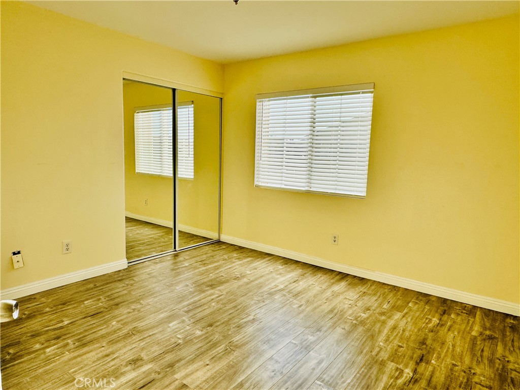 9329 Sable Ridge Avenue Hesperia, CA 92345 - Photo 20 of 31 a view of an empty room with wooden floor and a window