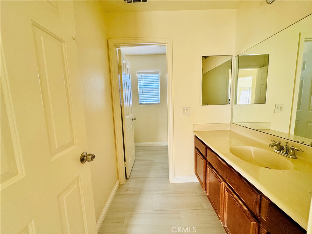 9329 Sable Ridge Avenue Hesperia, CA 92345 - Photo 27 of 31 a bathroom with a granite countertop sink and a mirror