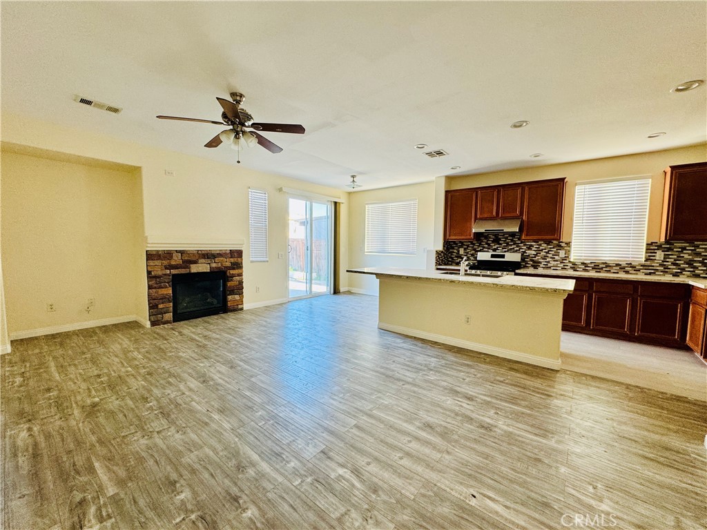9329 Sable Ridge Avenue Hesperia, CA 92345 - Photo 9 of 31 a large kitchen with stainless steel appliances granite countertop a stove and a wooden floors
