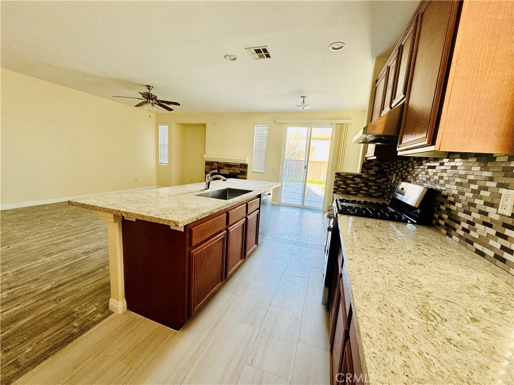 9329 Sable Ridge Avenue Hesperia, CA 92345 - Photo 10 of 31 a kitchen with a stove and a wooden floor