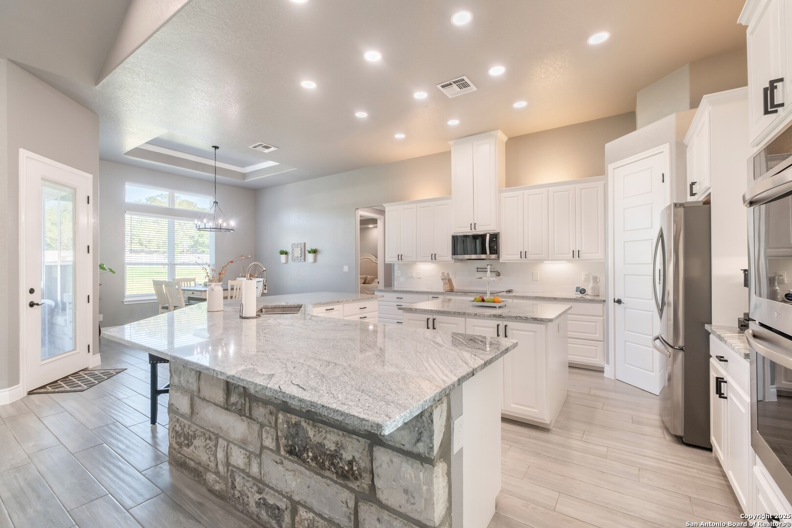 108 Timber Heights La Vernia, TX 78121 - Photo 12 of 42 a kitchen with a sink a counter top stainless steel appliances and cabinets