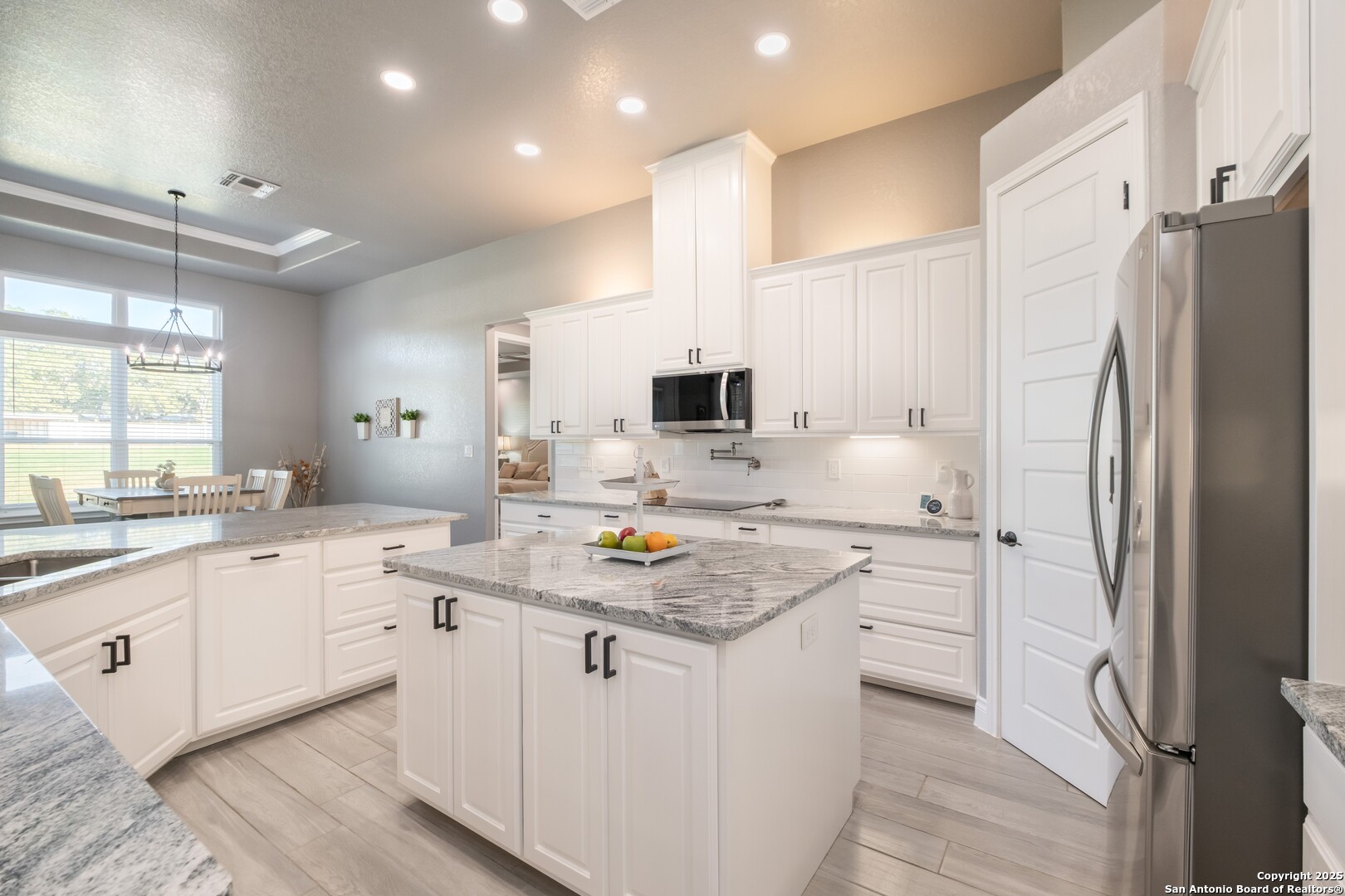 108 Timber Heights La Vernia, TX 78121 - Photo 13 of 42 a kitchen with stainless steel appliances granite countertop a sink stove and refrigerator