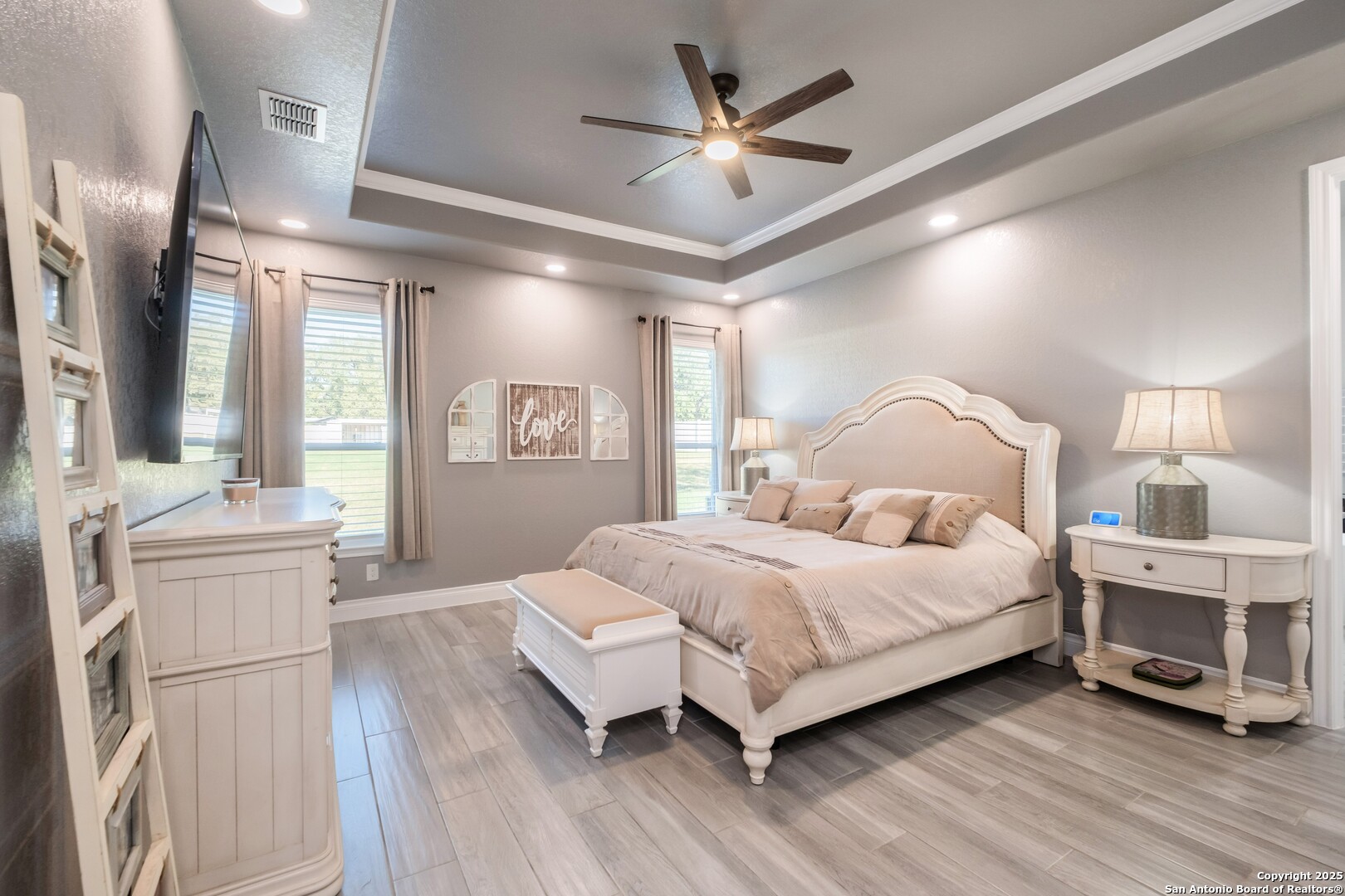 108 Timber Heights La Vernia, TX 78121 - Photo 18 of 42 a bedroom with a large bed and a chandelier