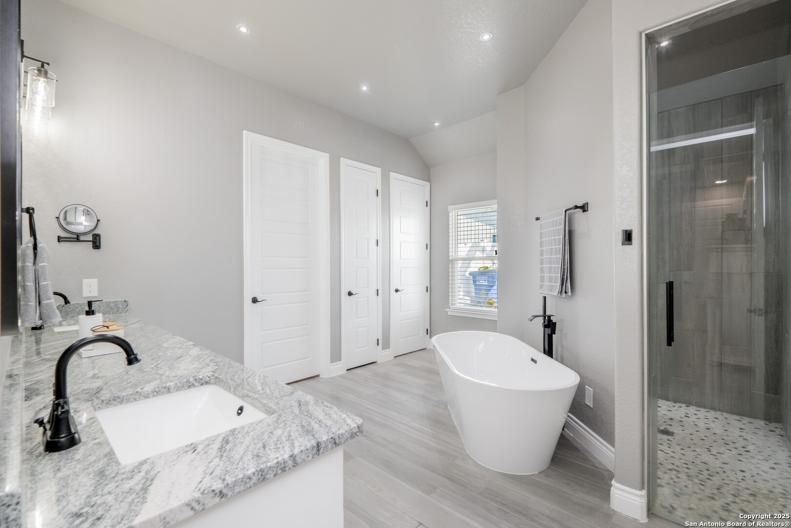 108 Timber Heights La Vernia, TX 78121 - Photo 20 of 42 a bathroom with a granite countertop sink a toilet and a tub