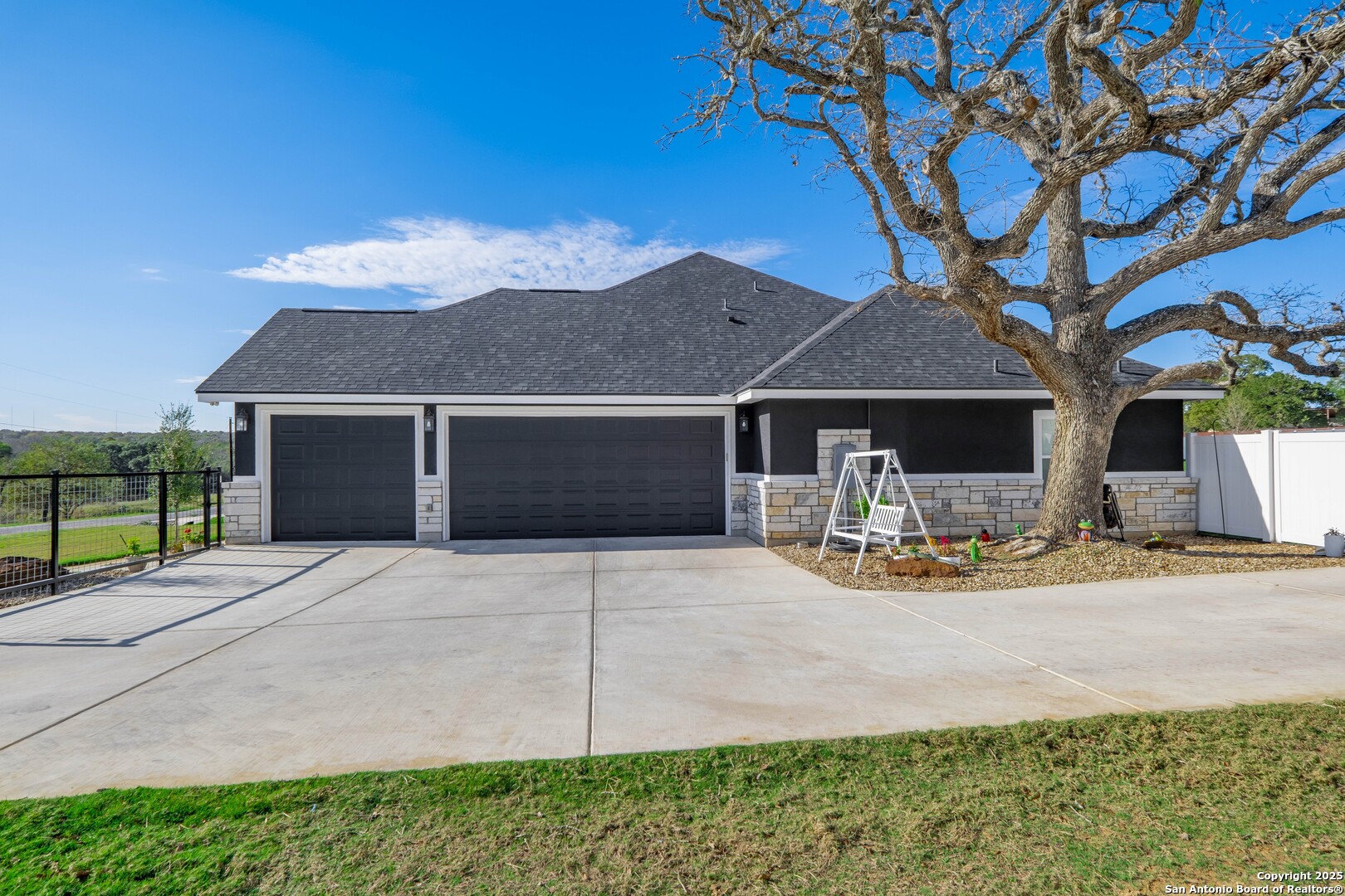 108 Timber Heights La Vernia, TX 78121 - Photo 3 of 42 a front view of a house with yard and garage