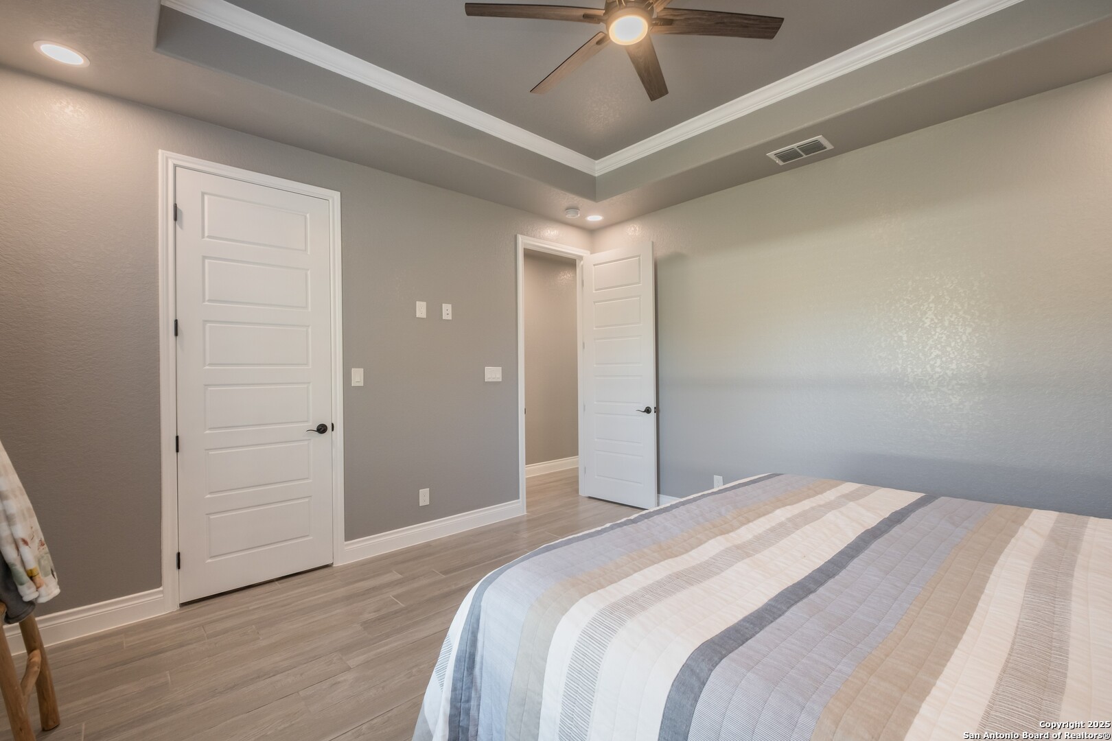 108 Timber Heights La Vernia, TX 78121 - Photo 31 of 42 a bedroom with a large bed and a chandelier fan