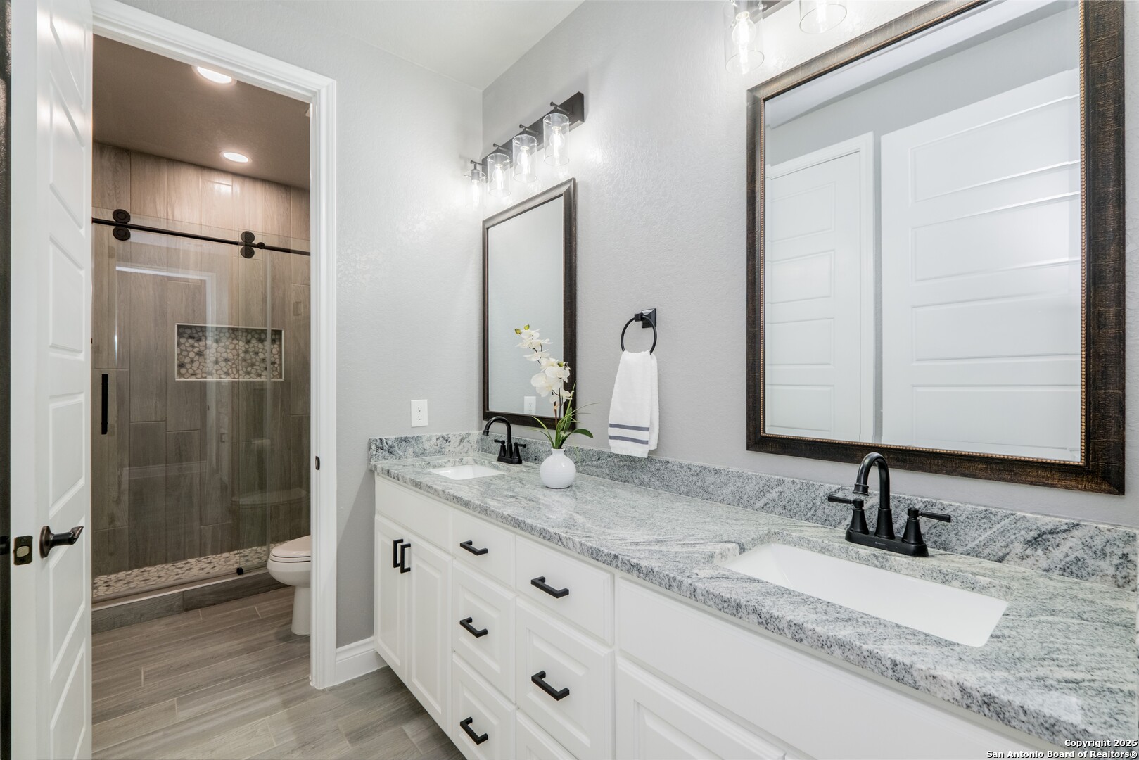 108 Timber Heights La Vernia, TX 78121 - Photo 32 of 42 a bathroom with a granite countertop sink and a mirror