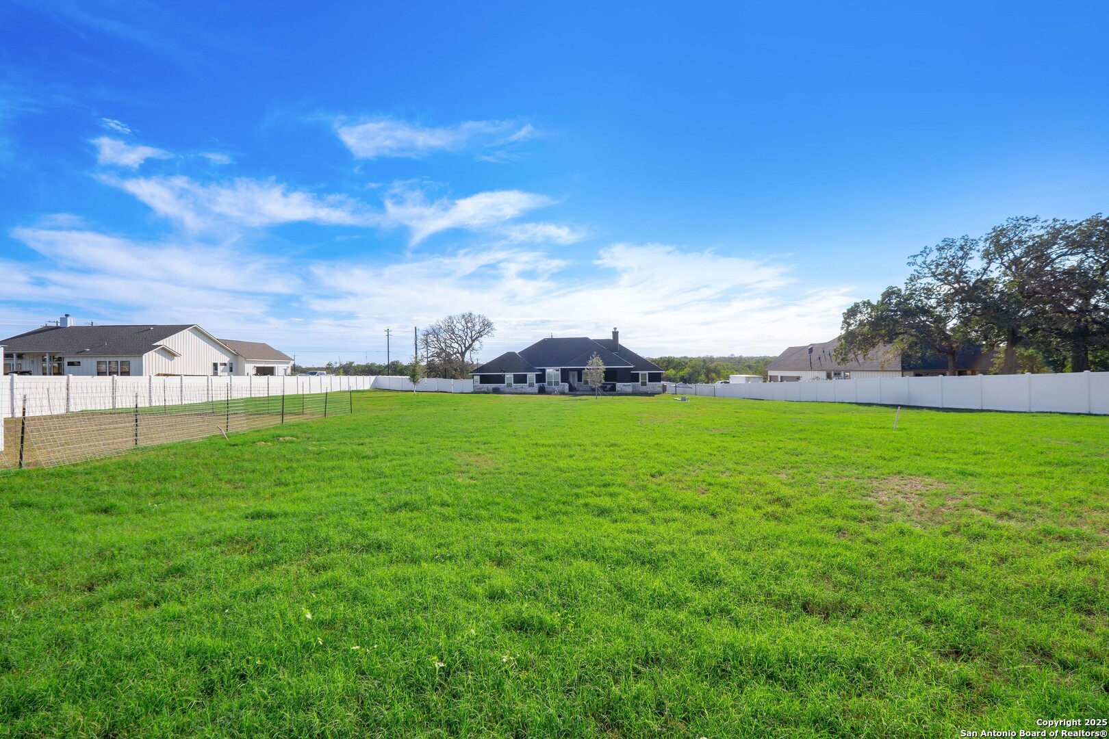 108 Timber Heights La Vernia, TX 78121 - Photo 39 of 42 a view of yard with lake and trees in the background