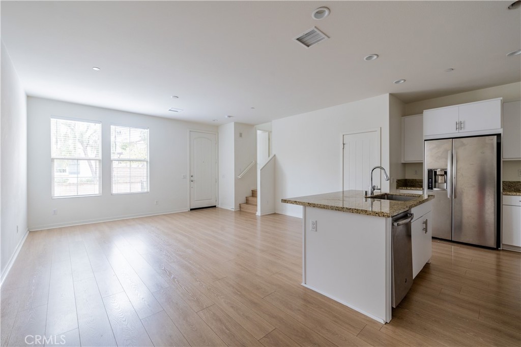 24 Prominence Lake Forest, CA 92630 - Photo 5 of 31 a kitchen with granite countertop a stove and a refrigerator