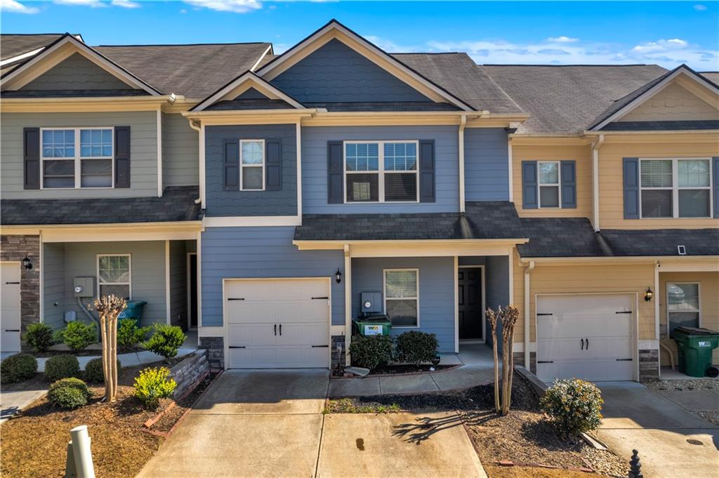 265 Valley Crossing Canton, GA 30114 - Photo 1 of 31 a front view of a house with garden
