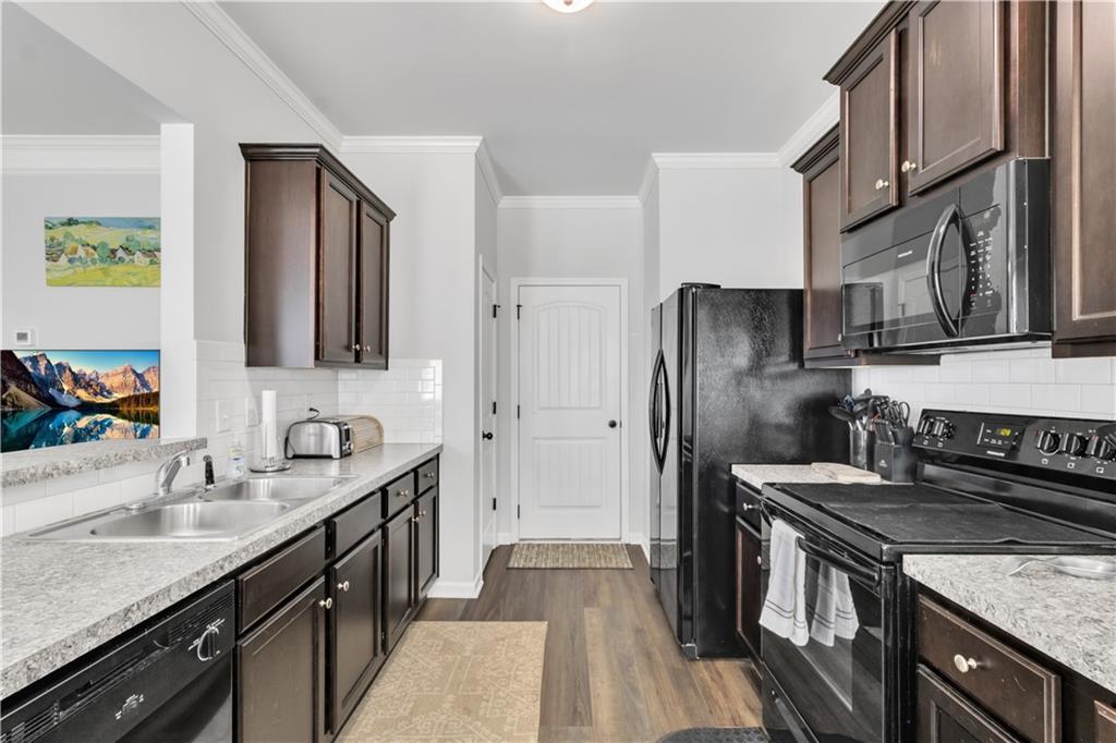 265 Valley Crossing Canton, GA 30114 - Photo 11 of 31 a kitchen with stainless steel appliances granite countertop a sink stove and refrigerator
