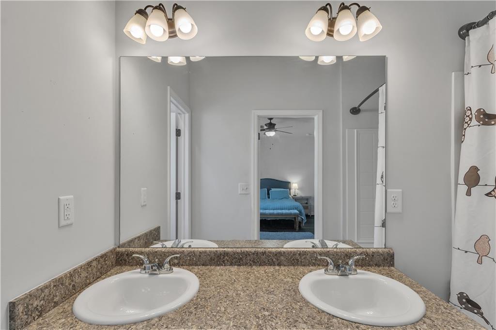 265 Valley Crossing Canton, GA 30114 - Photo 16 of 31 a bathroom with double vanity sinks and a mirror