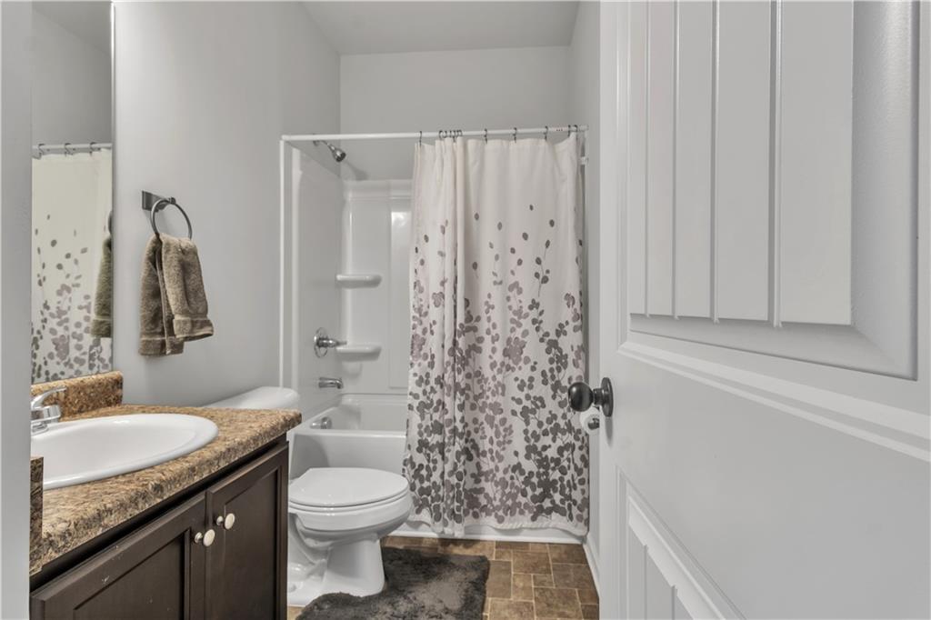 265 Valley Crossing Canton, GA 30114 - Photo 22 of 31 a bathroom with a granite countertop sink toilet and shower