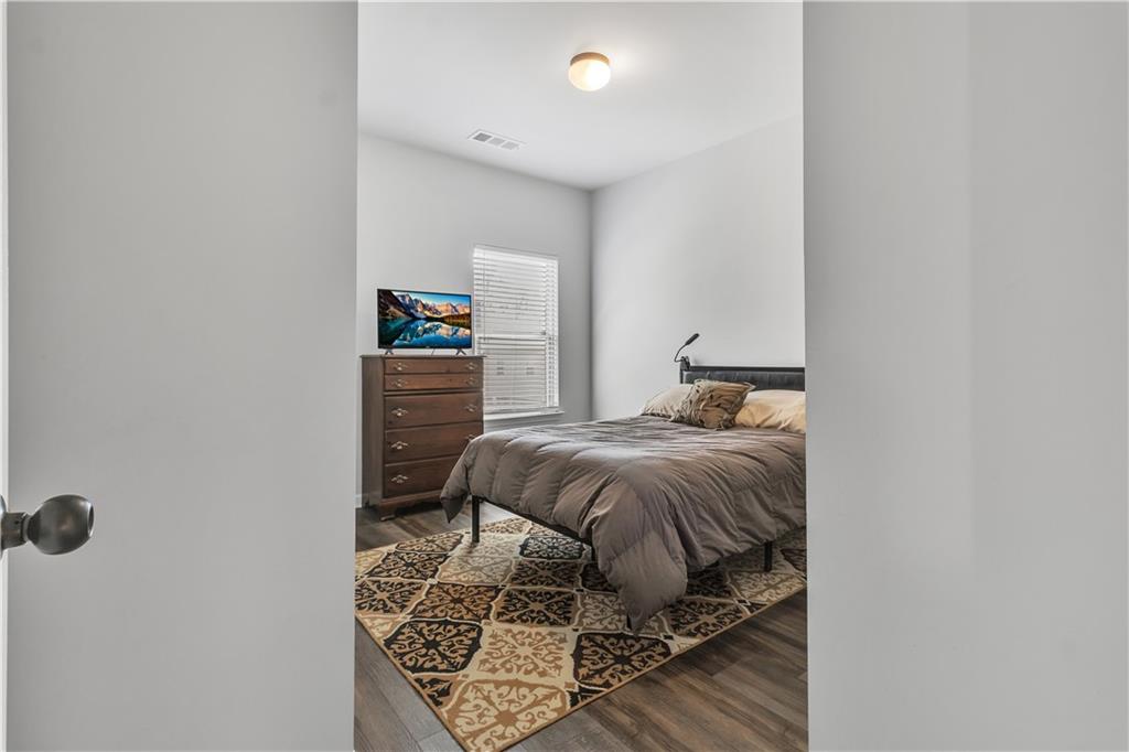 265 Valley Crossing Canton, GA 30114 - Photo 23 of 31 a bedroom with a bed and a table in it