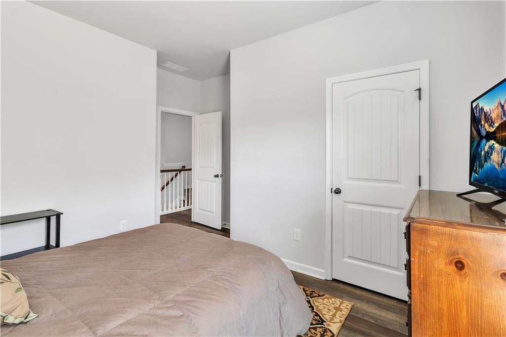 265 Valley Crossing Canton, GA 30114 - Photo 24 of 31 a bedroom with a bed and a flat tv screen on dresser