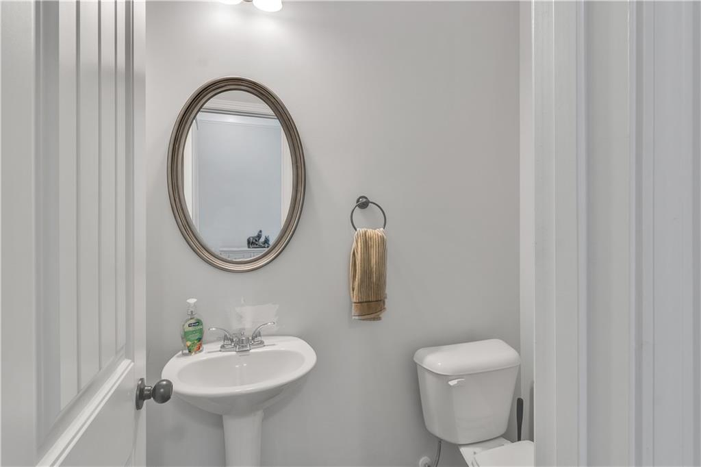 265 Valley Crossing Canton, GA 30114 - Photo 9 of 31 a bathroom with a toilet sink and mirror