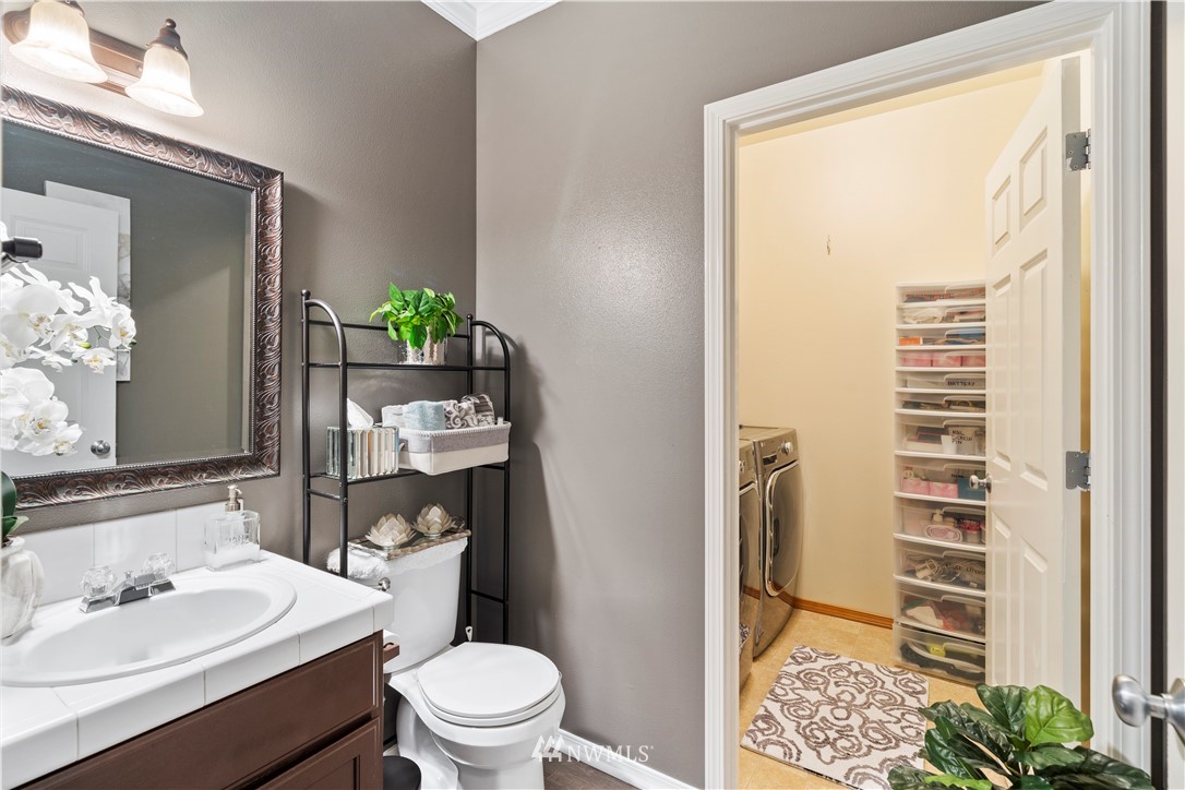 1162 Edmonds Place Northeast Renton, WA 98056 - Photo 14 of 25 a bathroom with a sink a toilet and shower curtain