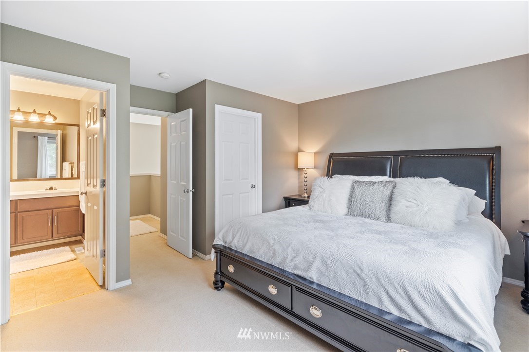 1162 Edmonds Place Northeast Renton, WA 98056 - Photo 18 of 25 a spacious bedroom with a bed and a view of bathroom