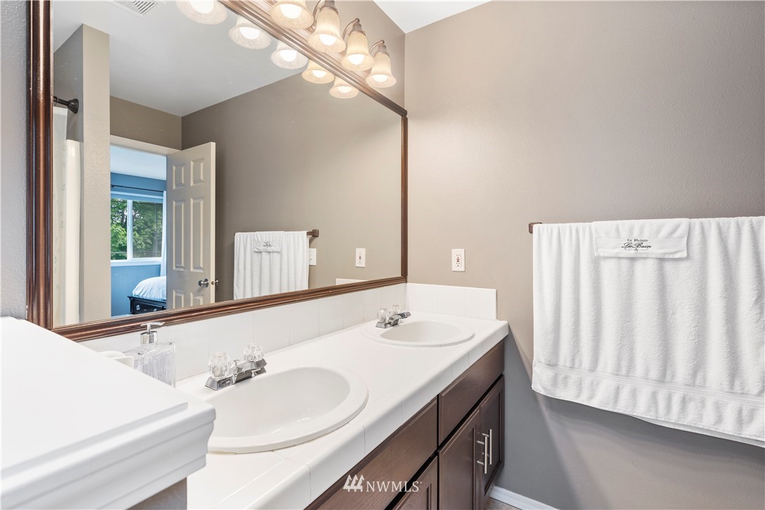 1162 Edmonds Place Northeast Renton, WA 98056 - Photo 19 of 25 a bathroom with a sink and a mirror