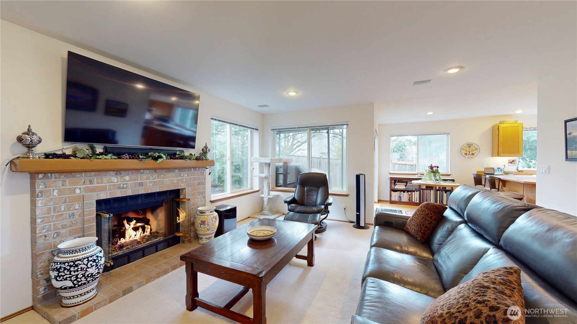 1704 Field Place Northeast Renton, WA 98059 - Photo 13 of 38 a living room with furniture a flat screen tv and a fireplace