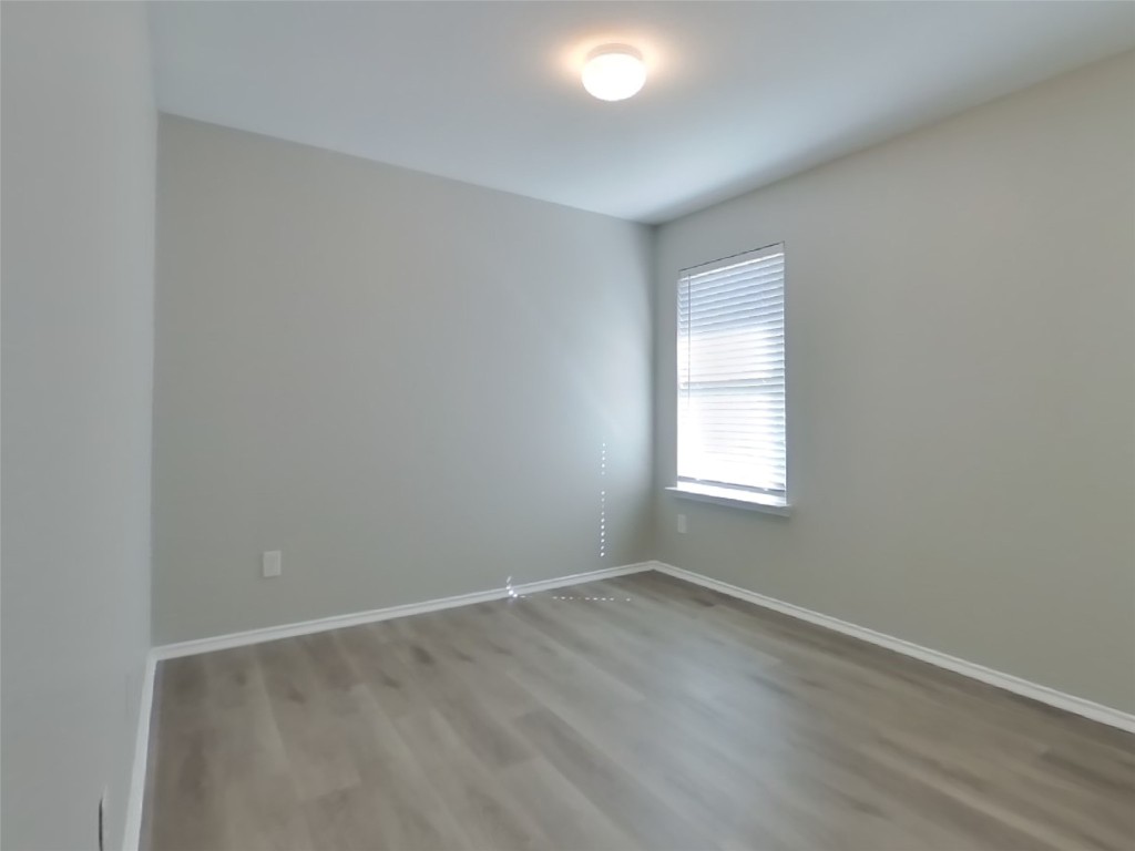 8523 Aster Glen Way Rosharon, TX 77583 - Photo 12 of 15 an empty room with wooden floor and windows