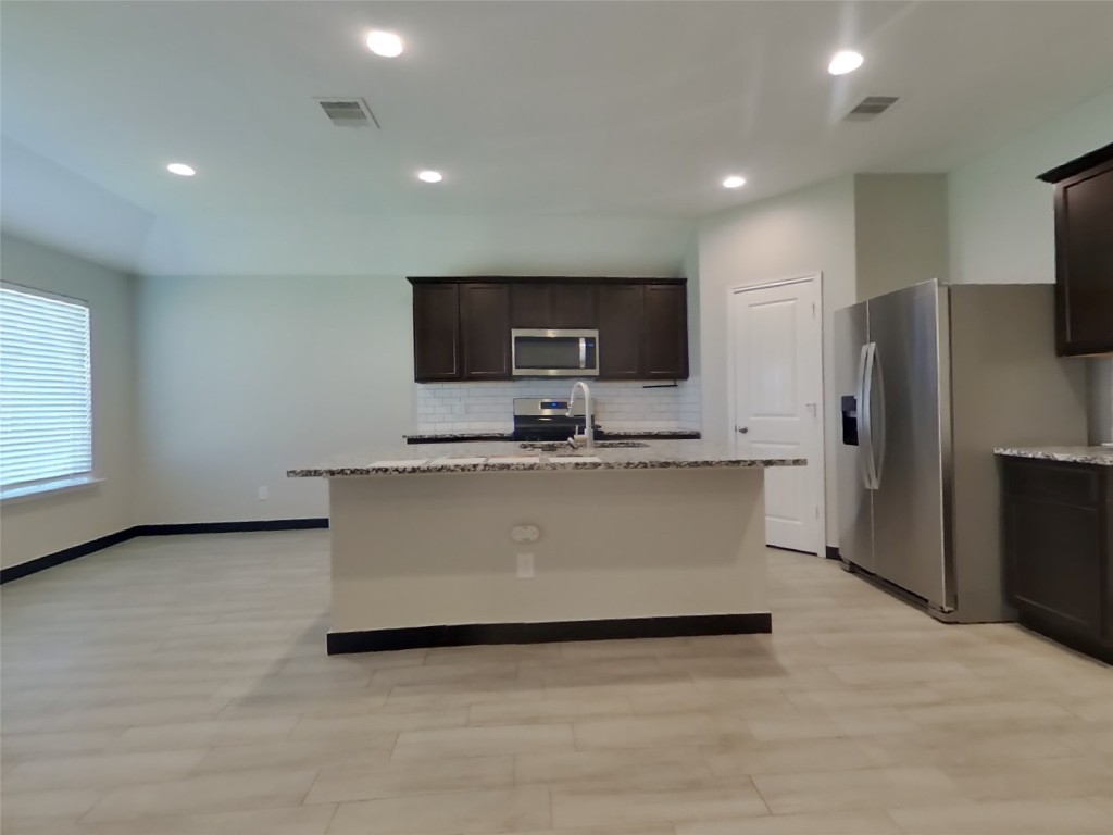 8523 Aster Glen Way Rosharon, TX 77583 - Photo 5 of 15 a view of kitchen with stainless steel appliances a refrigerator a microwave a sink and a counter top space