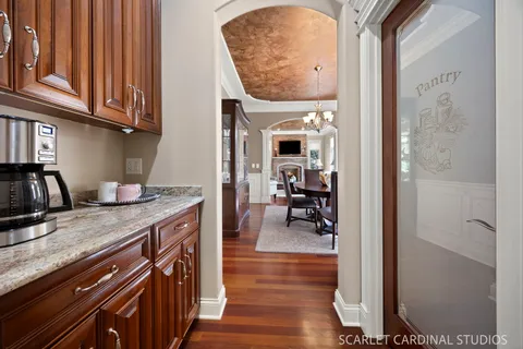 a kitchen with stainless steel appliances granite countertop a stove a sink dishwasher a refrigerator and a oven with wooden floor