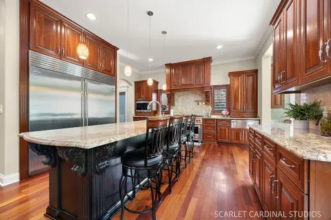 a kitchen with stainless steel appliances granite countertop a stove and a microwave