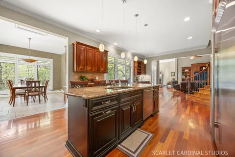 a kitchen with kitchen island granite countertop a stove and a sink